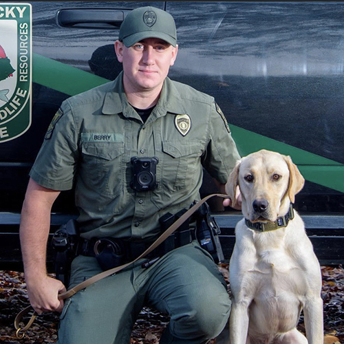 LE CO Cody Berry seated with K9 Gambit